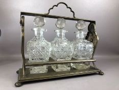 Metal tantalus with three cut glass decanters, approx 39cm in length (no key)