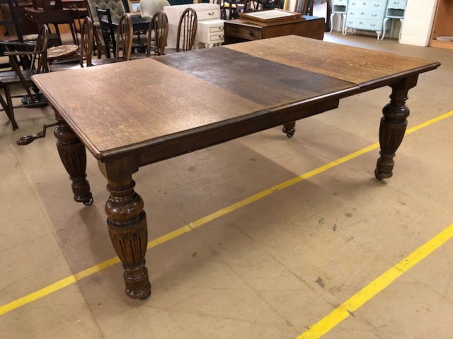 Extending dining table on baluster legs and castors, with winder, approx 182cm x 114cm (extended) - Image 2 of 5