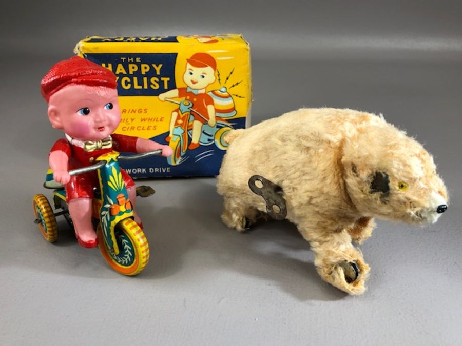 Vintage Toys: tinplate and plastic clockwork toy 'The Happy Cyclist' (A/F), in original box, and a