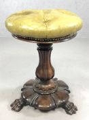 Heavily carved ornate stool on three large lion paw feet, with leather button seat, approx 50cm