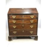 Antique bureau with fall front revealing pigeon holes and drawers, with brass fittings