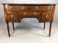 Antique writing desk on turned legs with brass fitments to five drawers, approx 106cm x 52cm x