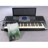 Yamaha PSR 1000 Keyboard with music stand, power cable and manuals