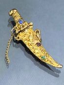 9ct Gold gold Pendant (375) of an Eastern Dagger set with gem stones approx 36mm long and 3.5g