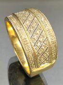 9ct Gold wide bodied gold ring set with Diamonds in three bands size approx 'V' & total weight 6.4g
