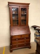 Modern bureau bookcase with fall front opening to pigeon holes and secret compartments, glazed