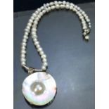 Seed Pearl necklace with Silver clasp and a Silver mounted mother of pearl shell with central