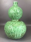 Chinese double gourd vase, monochrome green glaze, decorated in relief with foliate design with