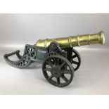 Brass Signal Cannon on a cast iron carriage with two eight-spoked wheels and pierced swept back