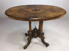 Antique oval occasional table on four turned supports and four splayed legs, the top with inlaid