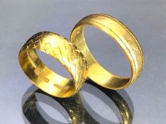 Two 22ct gold bands sizes 'T' & 'M' total weight approx 10.4g