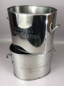 Pair of metal champagne coolers inscribed 'Alfred Gratien Champagne', each flanked by twin loop