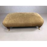 Large leather topped footstool on turned legs and casters approx 100 x 60 x 40cm tall