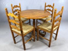 Circular pine pedestal table, diameter approx 90cm, with four pine rush seated chairs