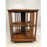 Rotating highly polished Canterbury or bookcase, with star inlaid detailing, approx 50cm x 50cm x