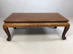 Coffee table with Eastern carved detailing, approx 105cm x 50cm x 40cm tall