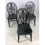Set of three black Windsor wheel back dining chairs