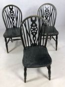Set of three black Windsor wheel back dining chairs