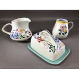 Small collection of Poole Pottery to include butter dish, handled jug or cup and a further jug (chip