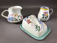 Small collection of Poole Pottery to include butter dish, handled jug or cup and a further jug (chip