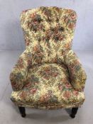 Antique upholstered button-back armchair, on turned front feet, with fire label to underside