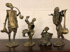 Set of four heavy brass African figures, the tallest approx 36cm in height