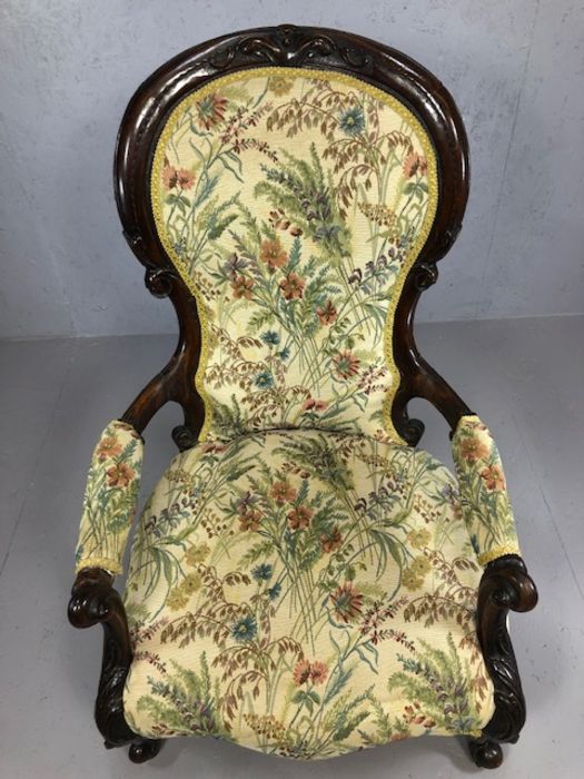 Heavily carved wooden framed low armchair, with floral fabric upholstery, approx 97cm tall - Image 3 of 5