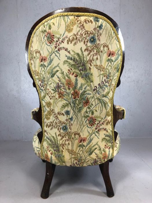 Heavily carved wooden framed low armchair, with floral fabric upholstery, approx 97cm tall - Image 5 of 5