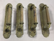 Four antique brass door pulls, each approx 30cm in length