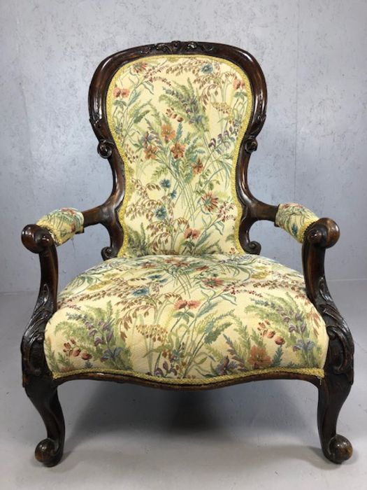Heavily carved wooden framed low armchair, with floral fabric upholstery, approx 97cm tall - Image 2 of 5