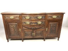 Mahogany carved sideboard on turned legs with carved leaf design and brass handles, approx 178cm x