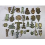 Artefact group of varying ages, mostly badges, brooches or pendants, circa 30 pieces