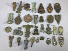 Artefact group of varying ages, mostly badges, brooches or pendants, circa 30 pieces