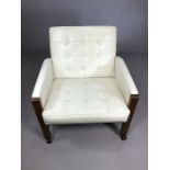 Mid Century white upholstered button back wooden framed armchair, on castors, in a 'Barcelona'