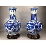 Two good size Chinese Blue and White baluster vases each with two blue circle marks to base and on