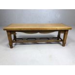Small low coffee table with square carved legs, approx 86cm x 30cm x 30cm