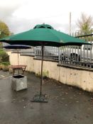 Large garden parasol approx 2m in diameter, on cast iron base