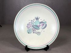 1950's Poole Pottery charger decorated in tones of purple and green. Approx 33cm Diameter.
