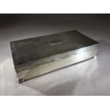 Silver hallmarked Art Deco Styled cigarette box on raised feet with wooden lining approx 16.5 x 8.