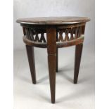 Modern circular hardwood table with lattice work design, approx 60cm in diameter