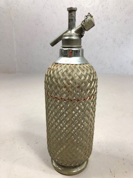 Vintage soda syphon with silver coloured metal grille marked Sparklets Ltd. London