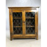 Glazed oak bookcase of linen fold design, approx 92cm x 31cm x 101cm tall