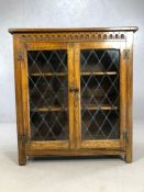Glazed oak bookcase of linen fold design, approx 92cm x 31cm x 101cm tall