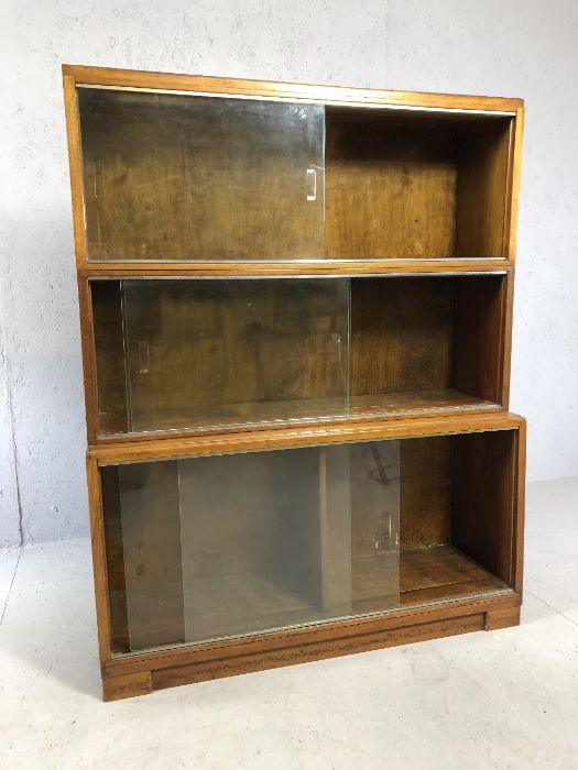 Mid Century modular three piece glass fronted bookcase, of waterfall design, approx 89cm x 29cm x