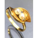 Unmarked Gold ring set with two pearls 'M'