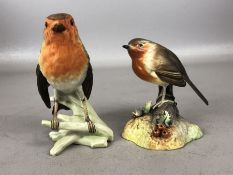 Two ceramic Robins, the first by Royal Crown Derby approx 10cm in height, the second by Goebel