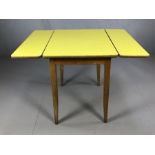 Mid Century kitchen table with two drop leaves on tapering legs