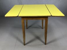 Mid Century kitchen table with two drop leaves on tapering legs