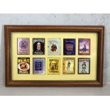 Framed collection of miniature vintage enamel advertising signs, each approx 8cm x 6cm, to include