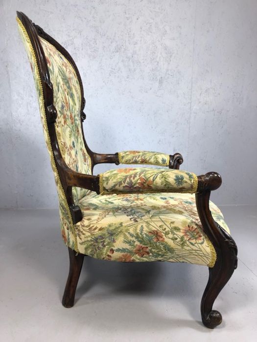 Heavily carved wooden framed low armchair, with floral fabric upholstery, approx 97cm tall - Image 4 of 5